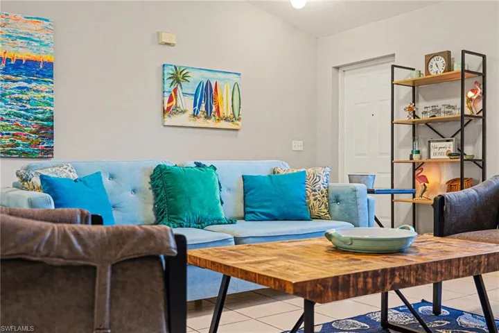 Living area featuring light gray walls and tile flooring