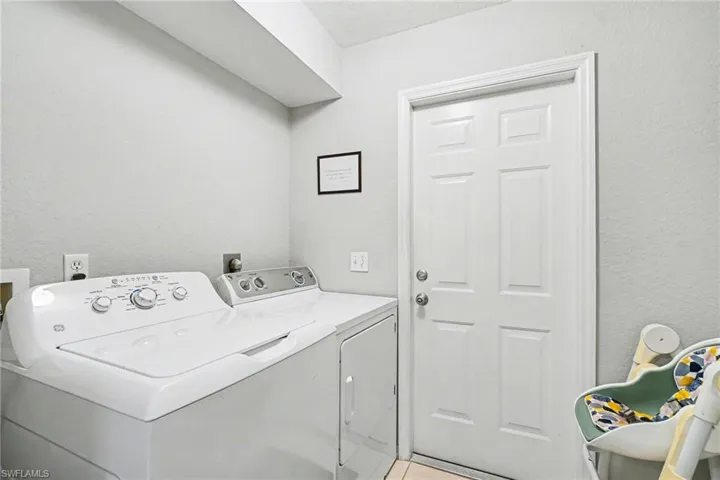 Laundry area with neutral wall tones and a paneled door