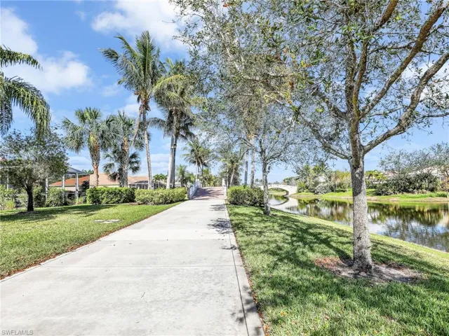 Surrounding community featuring a lawn and a water view