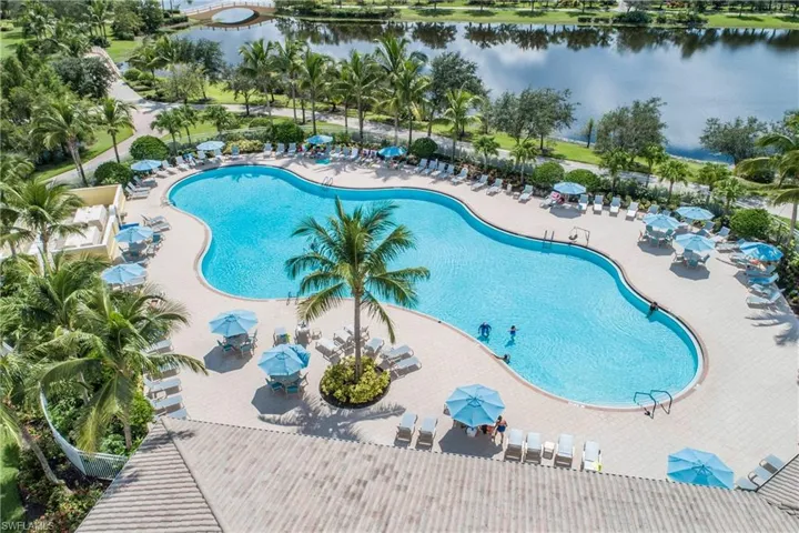 Community pool with a water view and a patio area