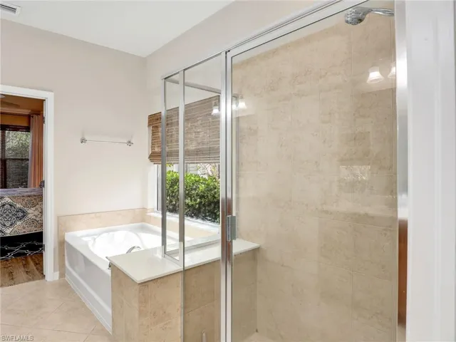 Ensuite bathroom featuring a stall shower, tile patterned flooring, connected bathroom, and a bath