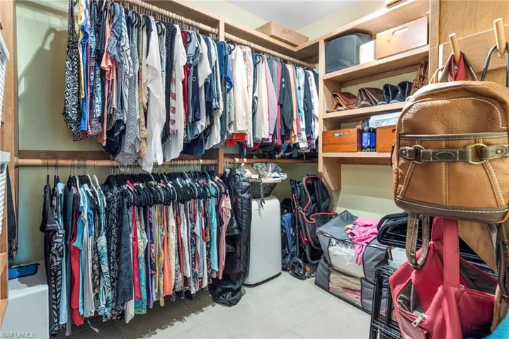 Walk in closet with tile floors
