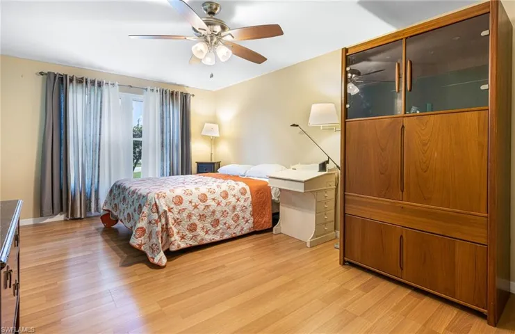 Bedroom with ceiling fan and light wood-type flooring