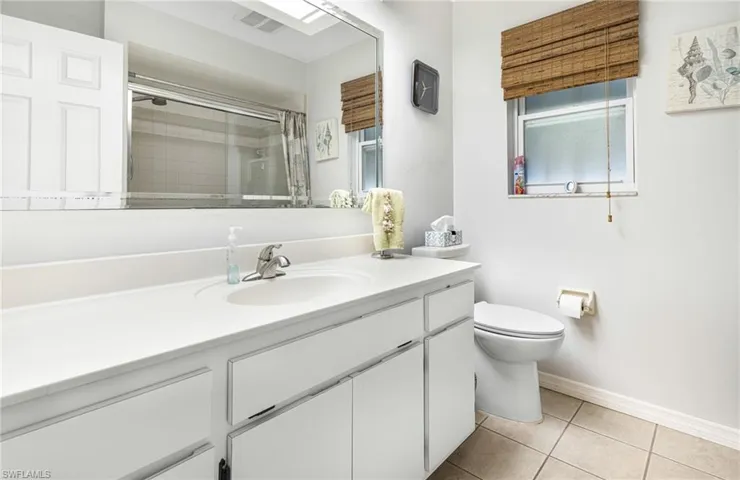 Bathroom with tile flooring, toilet, and vanity