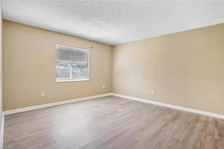 Spare room with light hardwood / wood-style floors and a textured ceiling