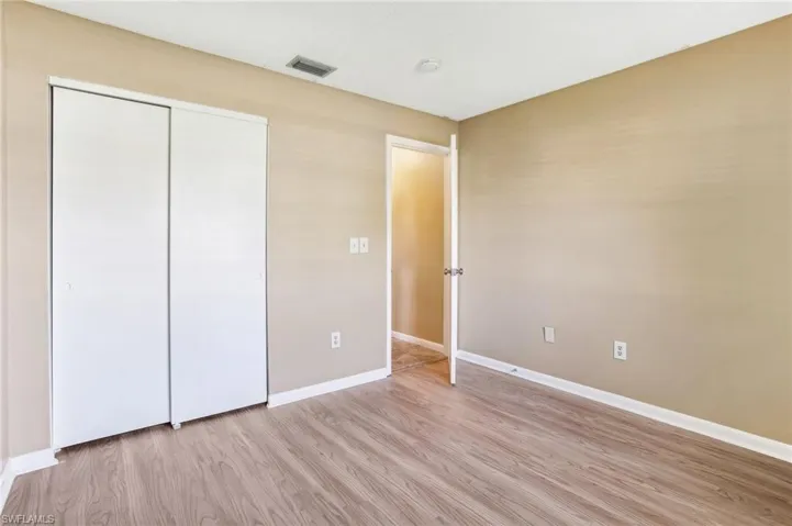 Unfurnished bedroom featuring a closet and light hardwood / wood-style flooring