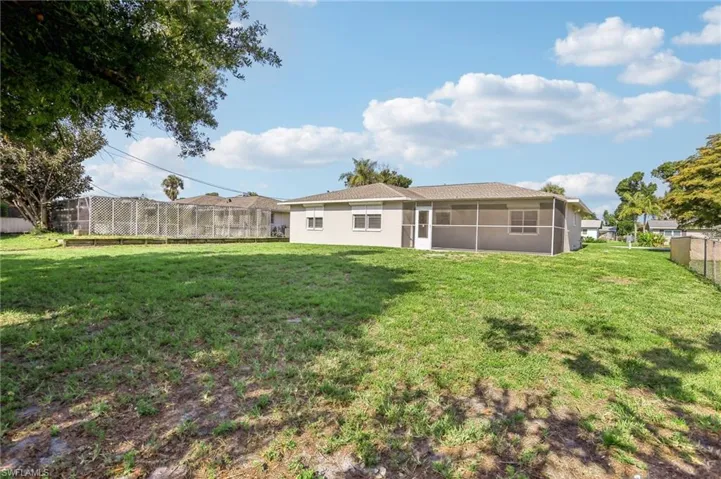 Rear view of property featuring a yard
