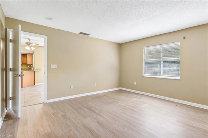 Spare room featuring sink, a textured ceiling, ceiling fan, and light wood-type flooring