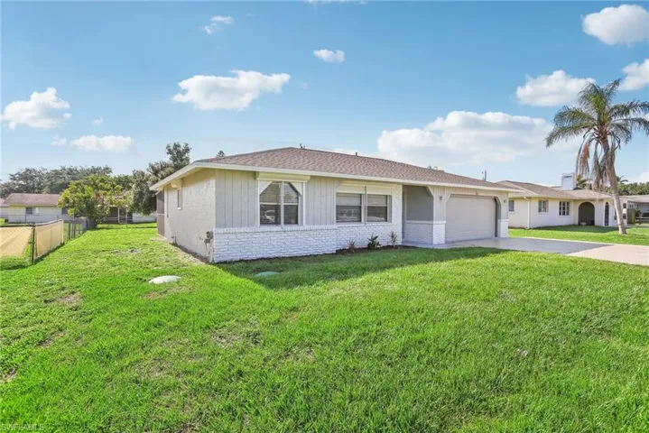 View of front of home featuring a garage and a front yard