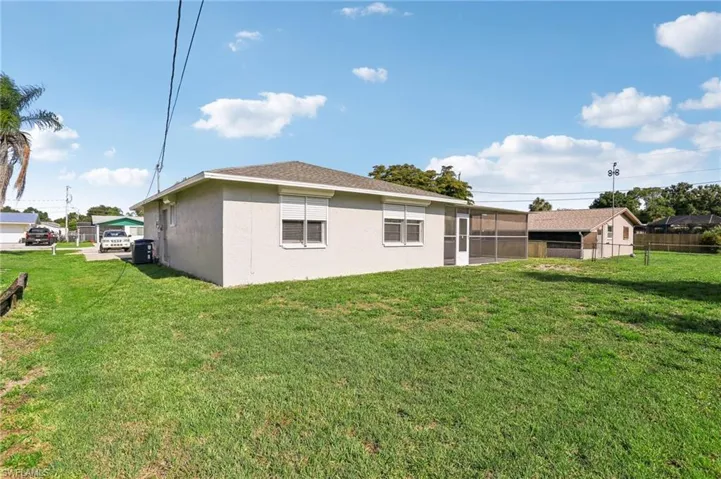 Back of house featuring a yard