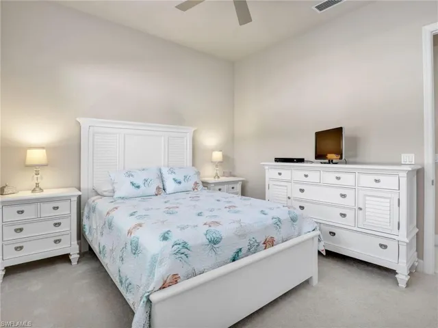 Carpeted bedroom with ceiling fan