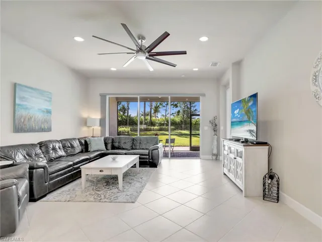 Tiled living room featuring ceiling fan