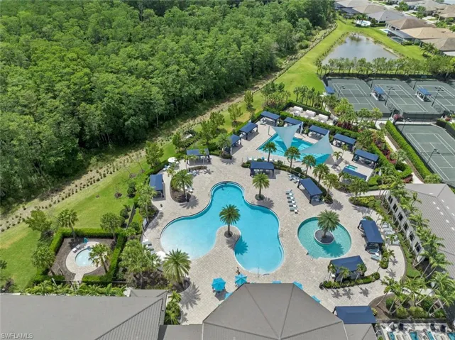 Birds eye view of property with a water view