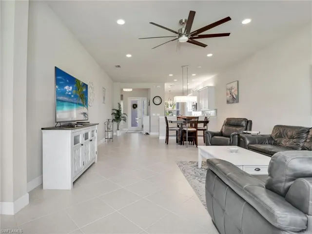 Tiled living room featuring ceiling fan
