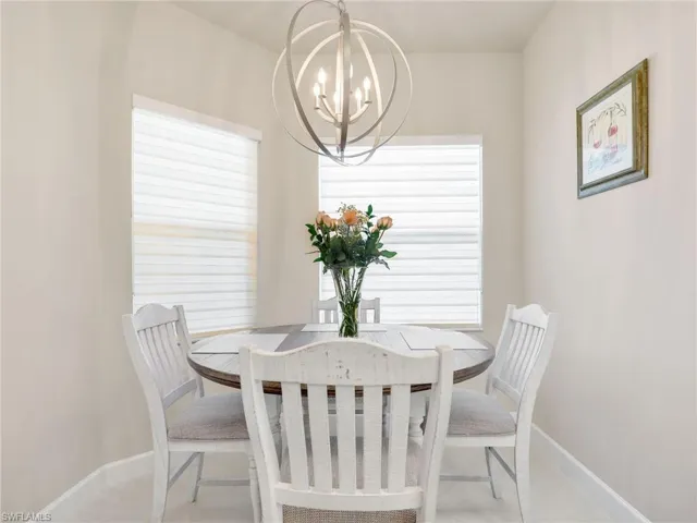 Dining room with a wealth of natural light and a notable chandelier