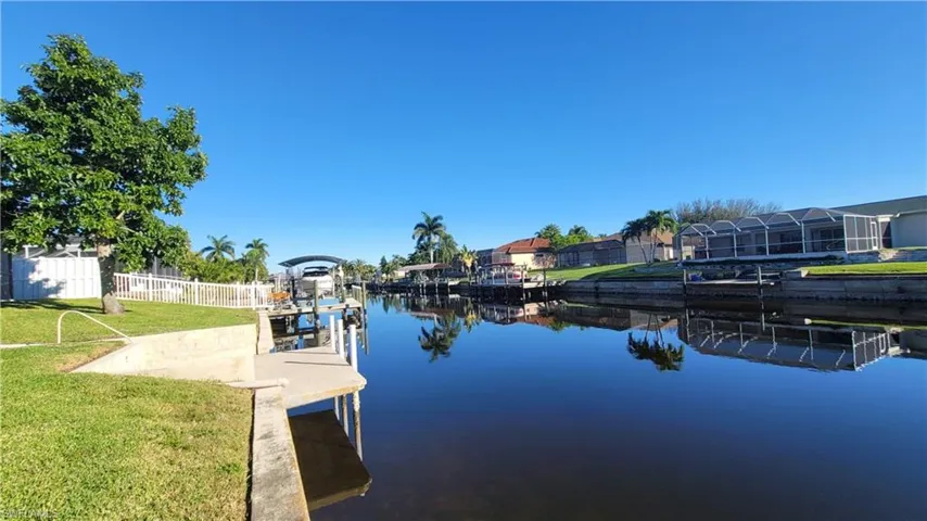 Dock with a water view and a residential view