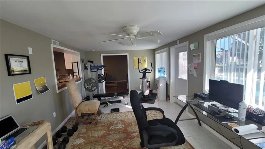 Office featuring a ceiling fan and light tile patterned floors