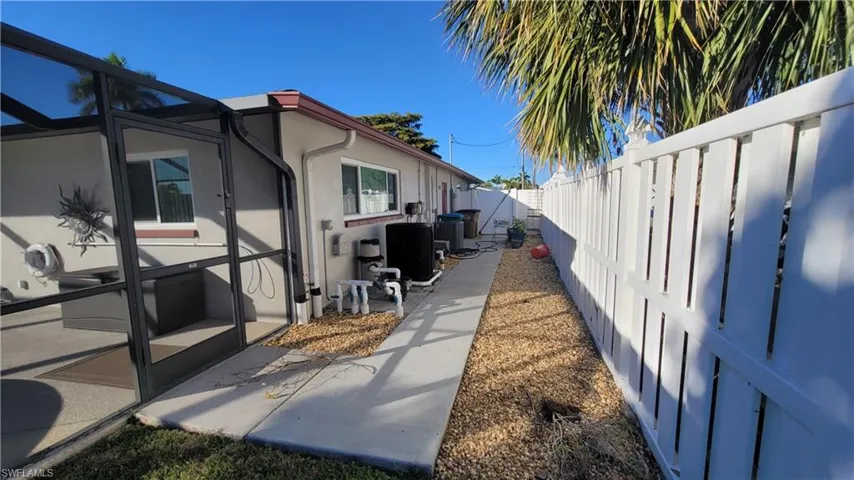 View of home's exterior with a lanai, a fenced backyard, a patio, stucco siding, and a sunroom