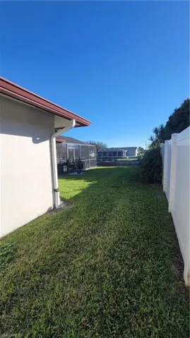 Fenced yard with a lanai and a sunroom