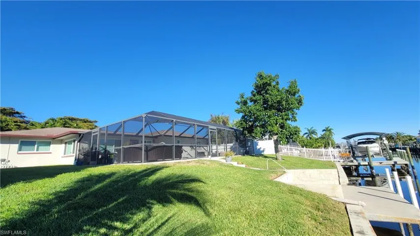Fenced yard with a lanai, a sunroom, and a patio area