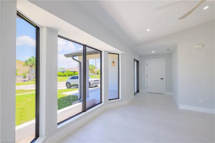 Empty room with ceiling fan and vaulted ceiling