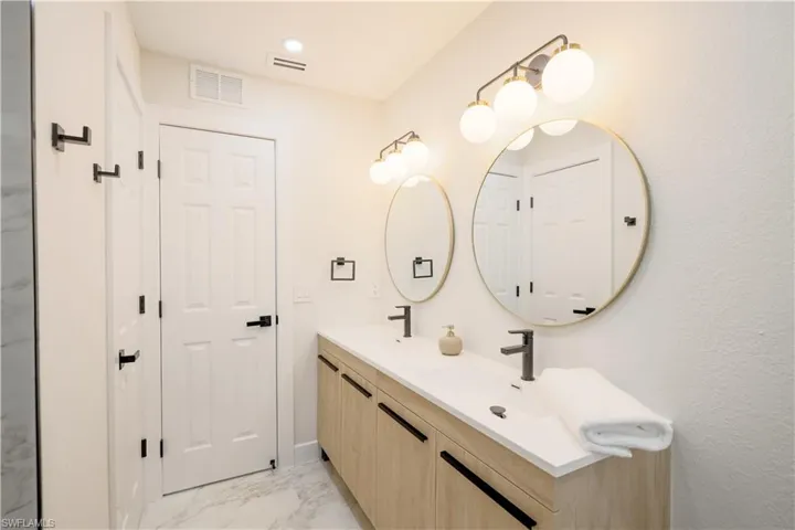 Bathroom with tile patterned flooring and vanity