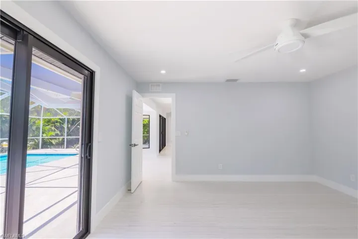 Empty room featuring ceiling fan and light hardwood / wood-style floors