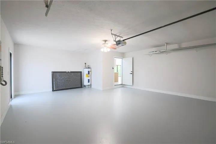 Garage with a garage door opener and electric water heater