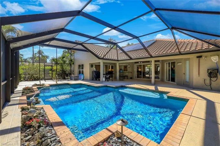 Swimming pool featuring a sunroom, a patio, and a lanai