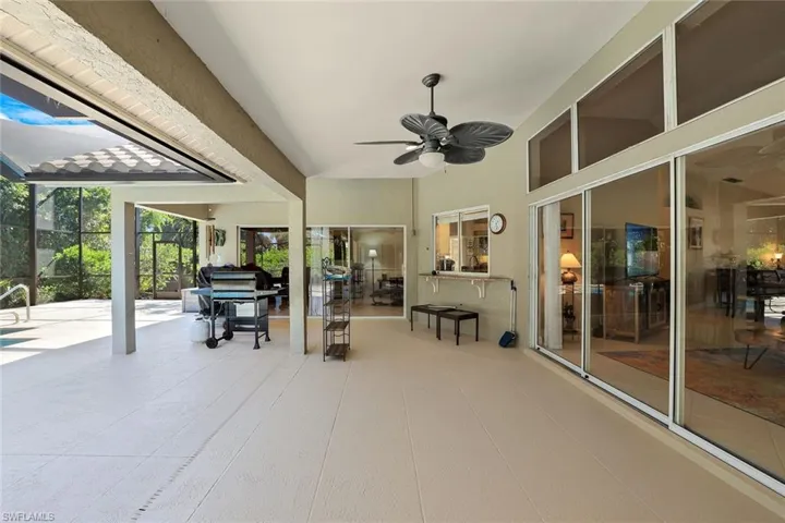 View of patio with ceiling fan, a grill, a lanai, and a sunroom
