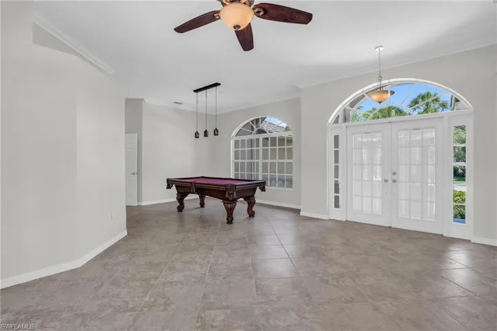 Entrance foyer featuring tile flooring, pool table, ceiling fan, and french doors