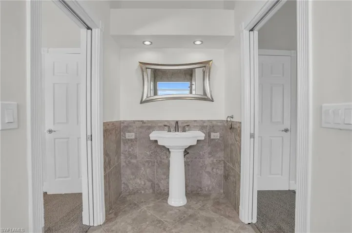 Bathroom with tile walls and tile floors