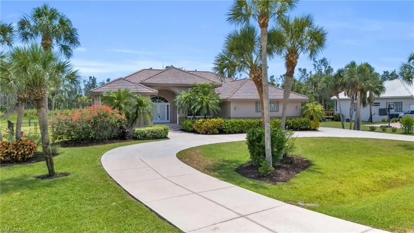 Mediterranean / spanish home featuring a front lawn