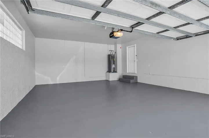 Garage with a garage door opener and electric water heater