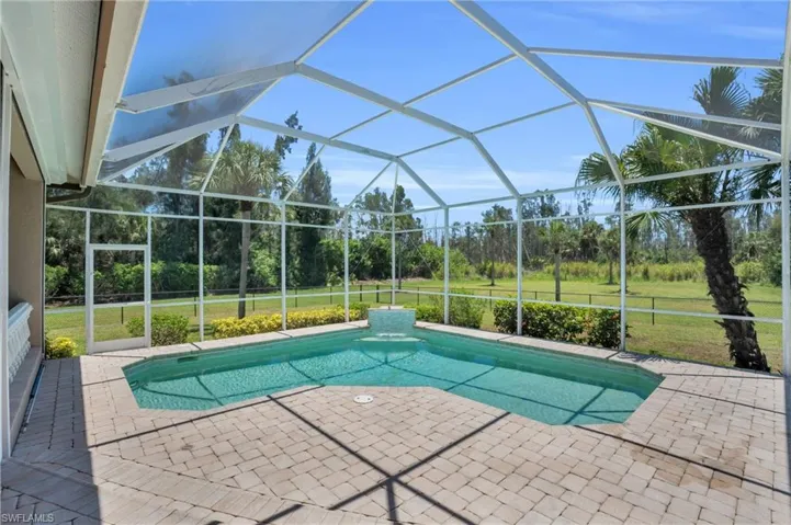 View of swimming pool with a yard, a lanai, and a patio
