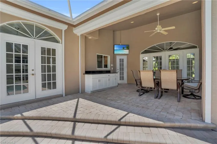 View of terrace with ceiling fan and french doors