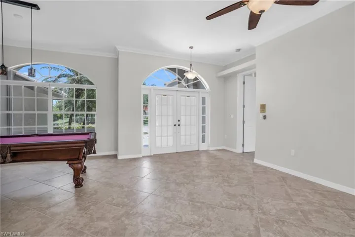 Foyer entrance with tile flooring, a wealth of natural light, and french doors