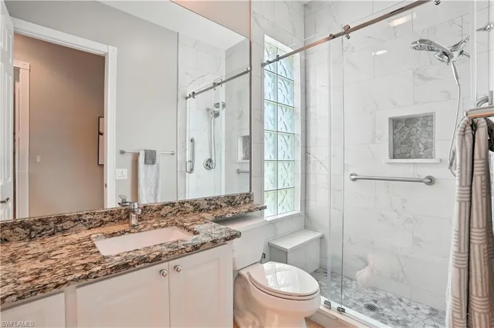 Bathroom with vanity and a shower stall