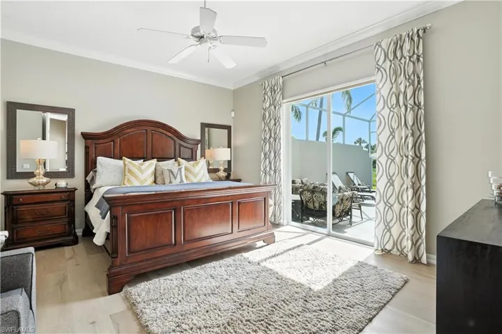 Bedroom featuring access to outside, ornamental molding, light wood finished floors, and a ceiling fan