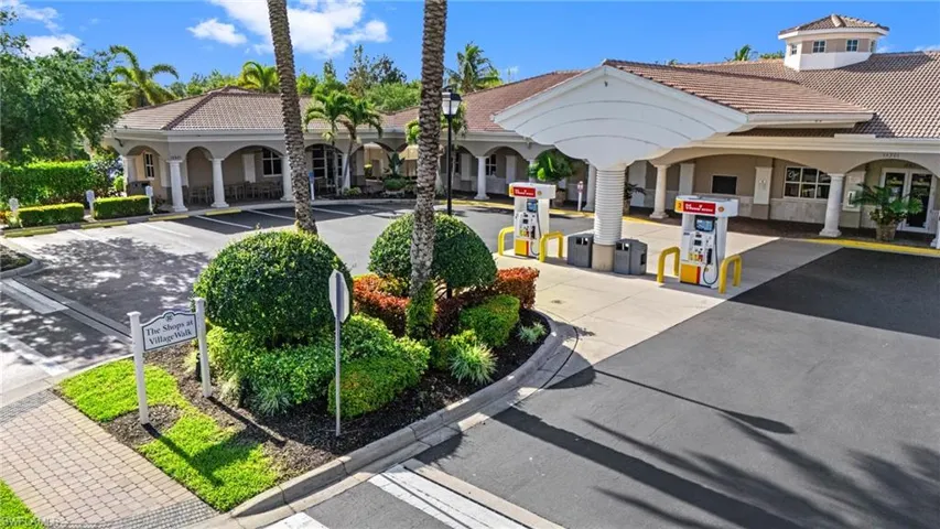 View of property's community featuring gas station, community post office, restaurant , and hair salon.