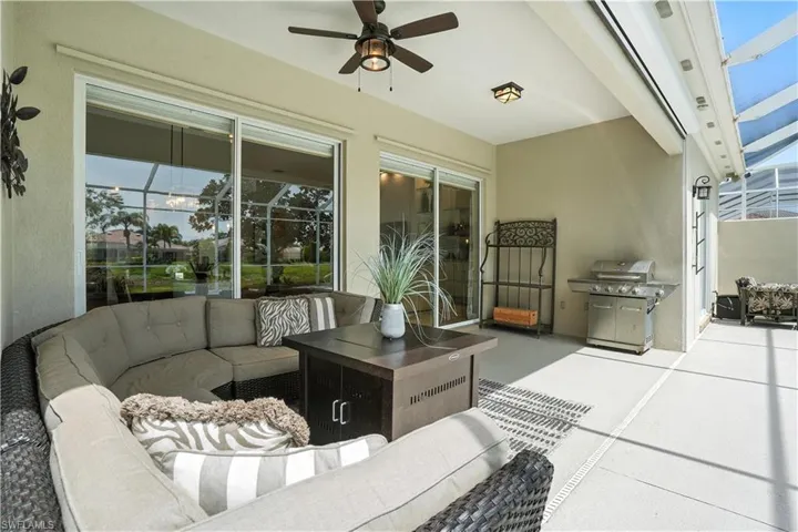 View of patio featuring an outdoor hangout area, a grill, a ceiling fan, and a lanai
