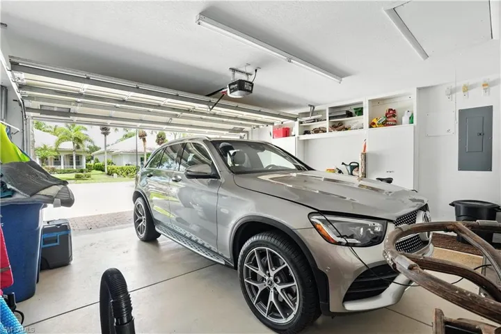 Garage featuring electric panel and a garage door opener