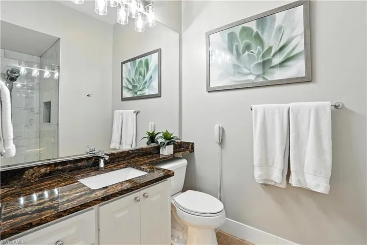 Full bath with vanity and tiled shower