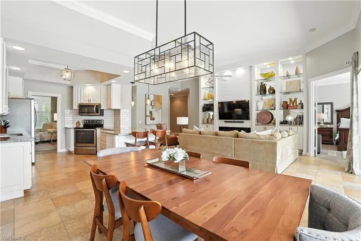 Dining room with ornamental molding and ceiling fan