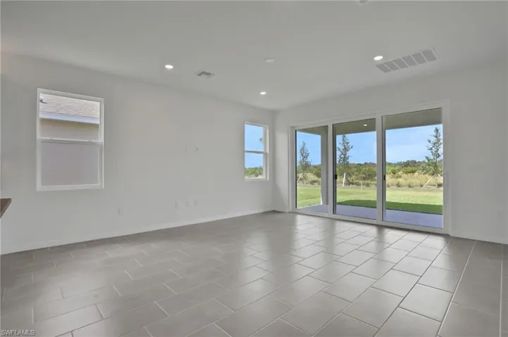 Unfurnished room featuring recessed lighting and light tile patterned floors