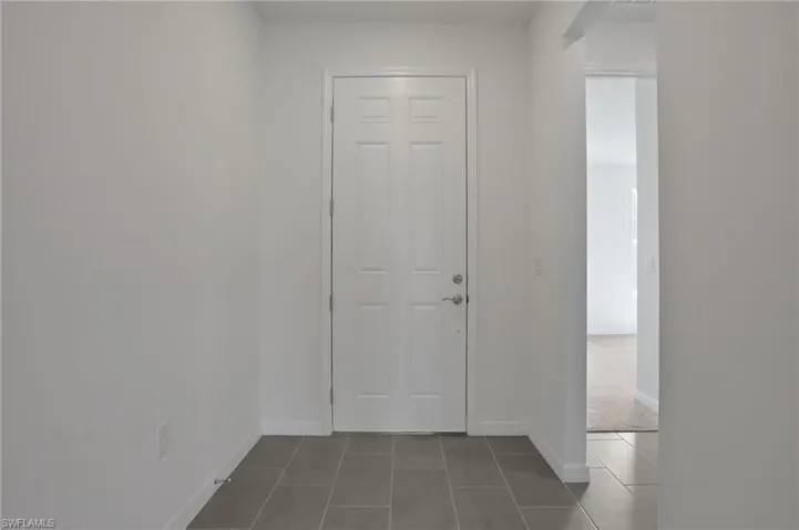 Entrance foyer with baseboards and tile patterned floors