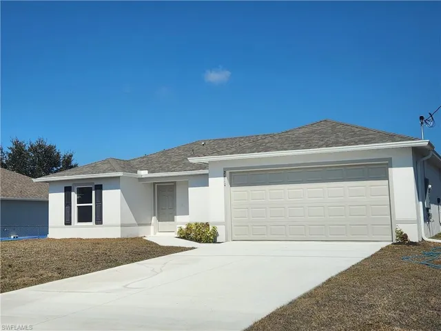 Ranch-style home with stucco siding, concrete driveway, a garage, and roof with shingles