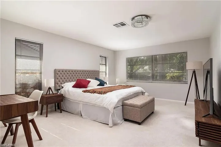 Light-filled room featuring neutral wall paint and plush carpeting