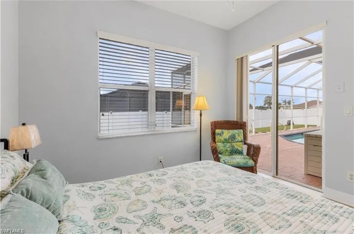 Sliding glass door leading to an enclosed screened patio with a pool