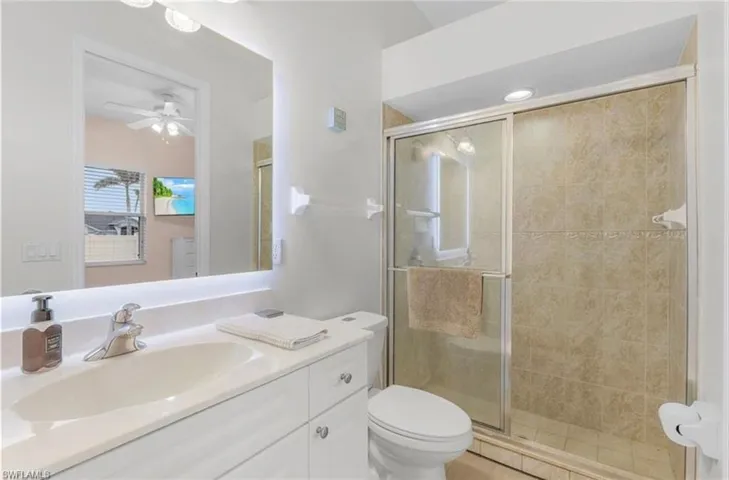 Vanity with integrated sink, chrome faucet, and under-lit mirror